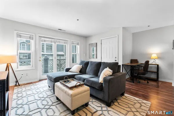 a living room with furniture and large windows