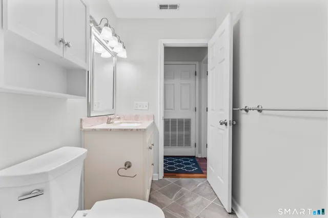 a bathroom with a sink a toilet a shower and a mirror