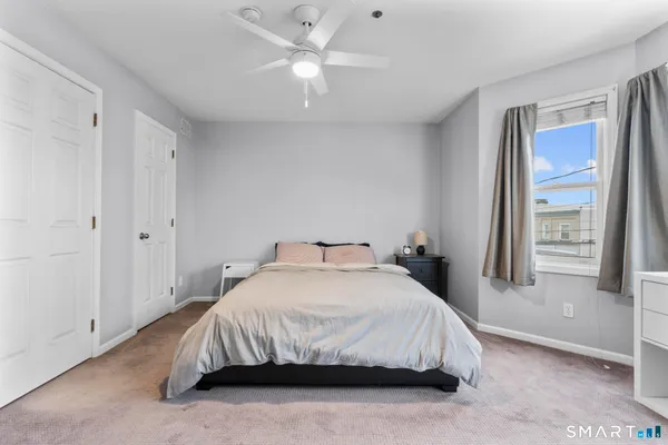 a bedroom with a bed and a window