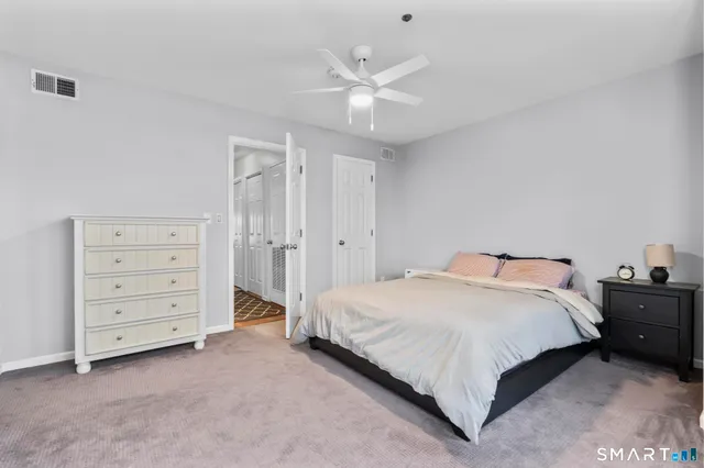 a spacious bedroom with a bed and closet