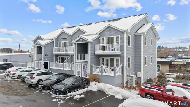 a city street lined with parked cars and buildings