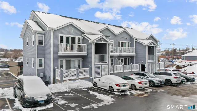 a car parked in front of a white house