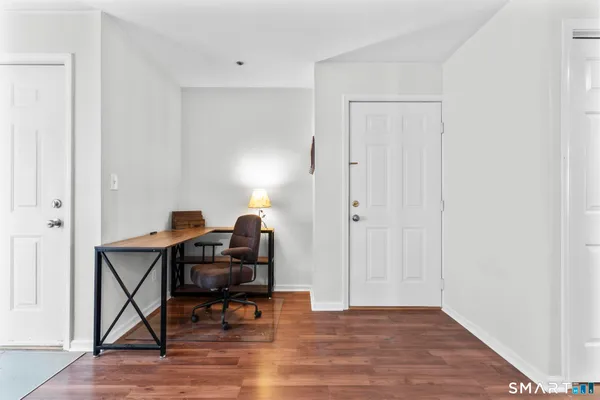 a workspace with furniture and wooden floor