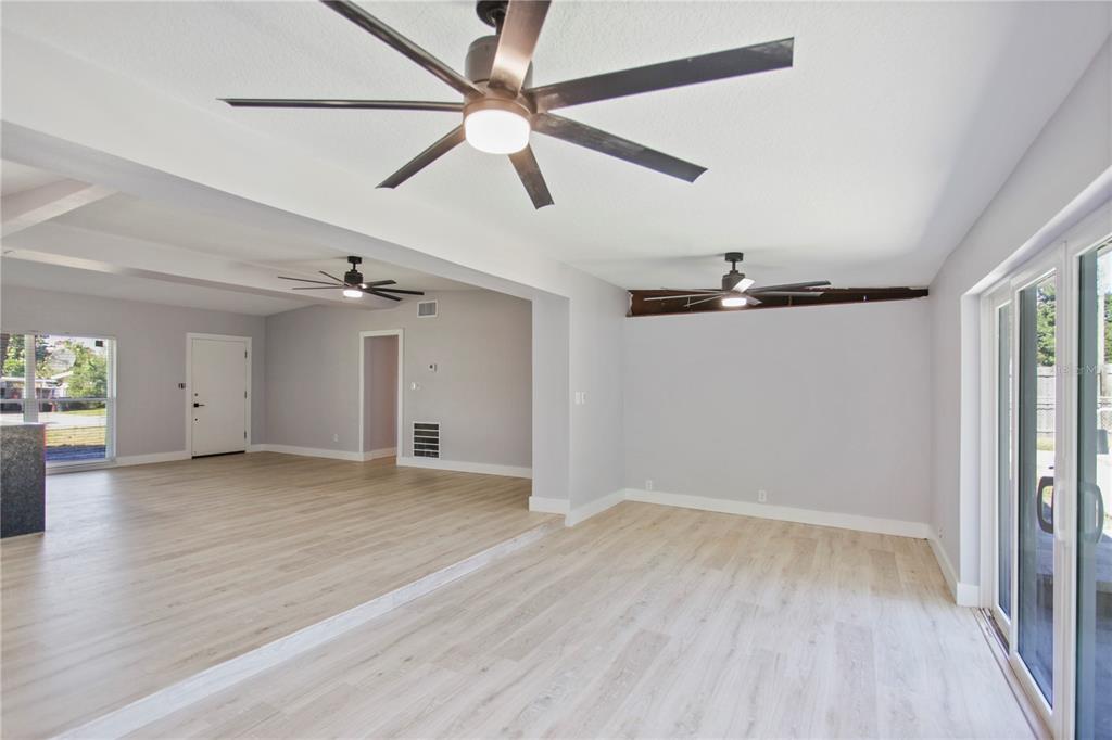 1407 Berwyn Road Orlando, FL 32806 - Photo 13 of 42 an empty room with wooden floor fan and windows