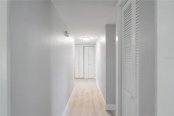 a view of a hallway with wooden floor