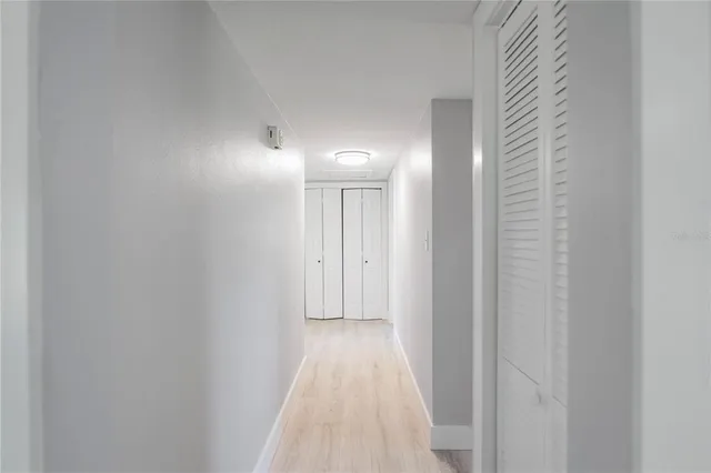 a view of a hallway with wooden floor