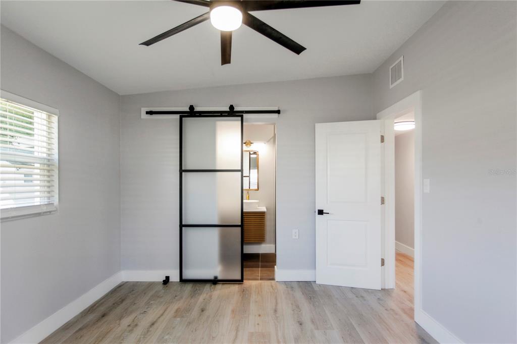 1407 Berwyn Road Orlando, FL 32806 - Photo 19 of 42 a view of empty room with wooden floor and window