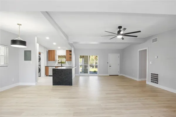 a view of a livingroom with kitchen appliances