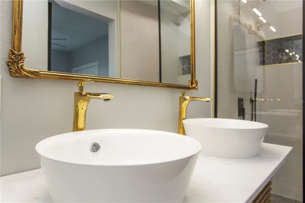 a white bath tub sitting next to a white sink