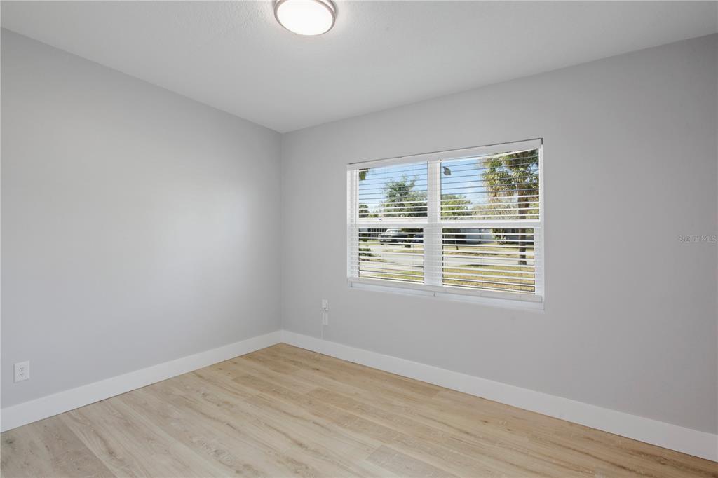 1407 Berwyn Road Orlando, FL 32806 - Photo 26 of 42 a view of an empty room with wooden floor and a window