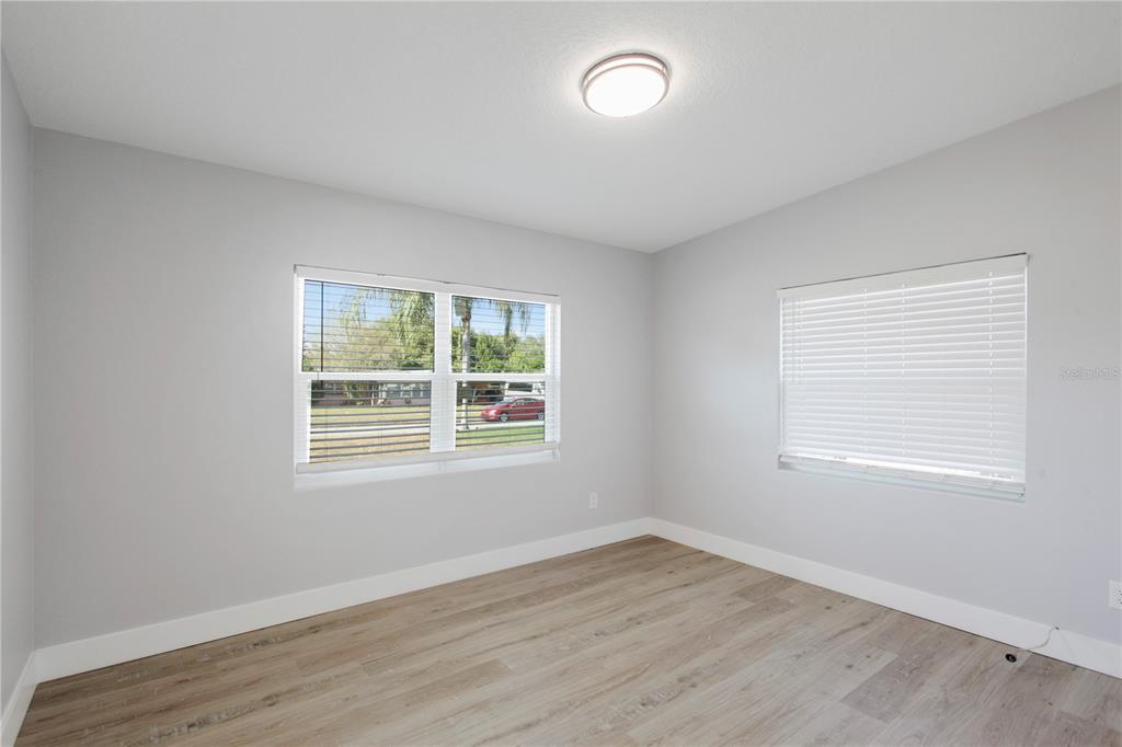 1407 Berwyn Road Orlando, FL 32806 - Photo 27 of 42 an empty room with wooden floor and windows