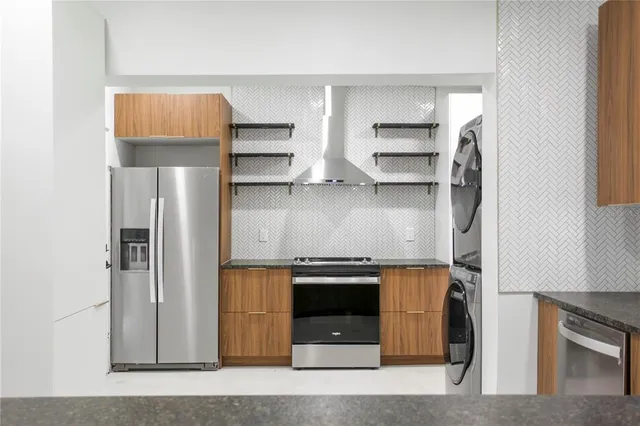 a kitchen with stainless steel appliances granite countertop a stove and a refrigerator