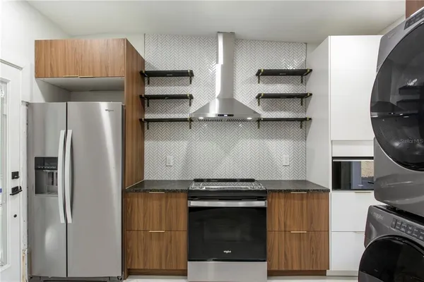 a kitchen with stainless steel appliances and wood cabinets