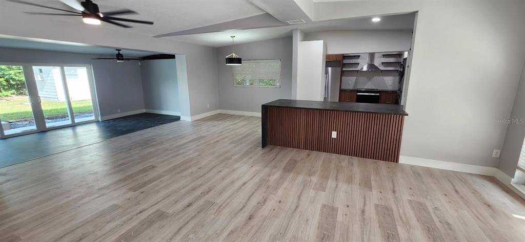 1407 Berwyn Road Orlando, FL 32806 - Photo 9 of 42 an empty room with wooden floor and windows