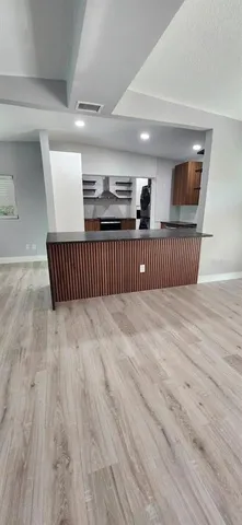 a view of hallway with wooden floor