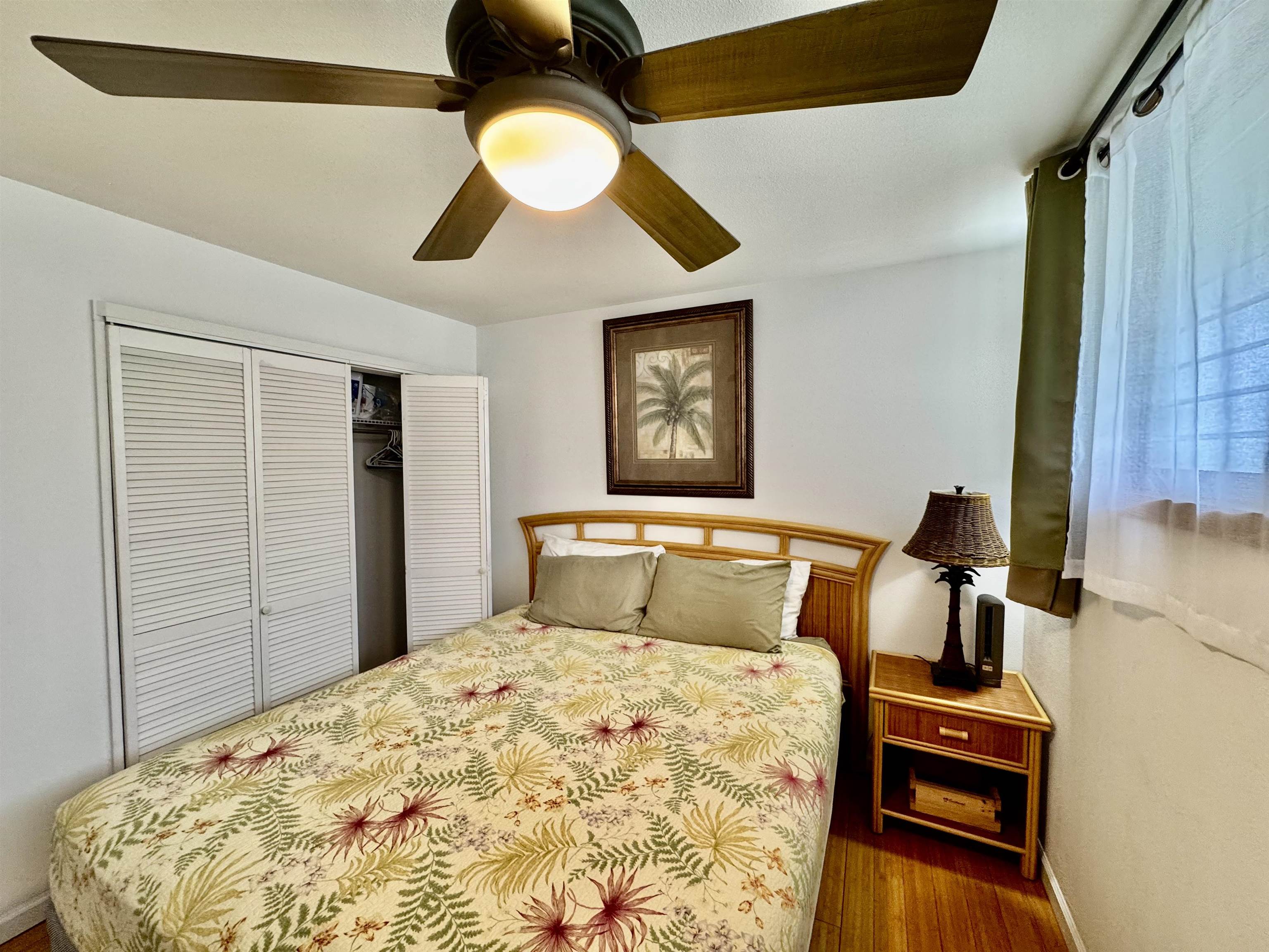 7142 Kamehameha V Highway, Unit A110 Kaunakakai, HI 96748 - Photo 11 of 20 a bedroom with a bed and a chandelier