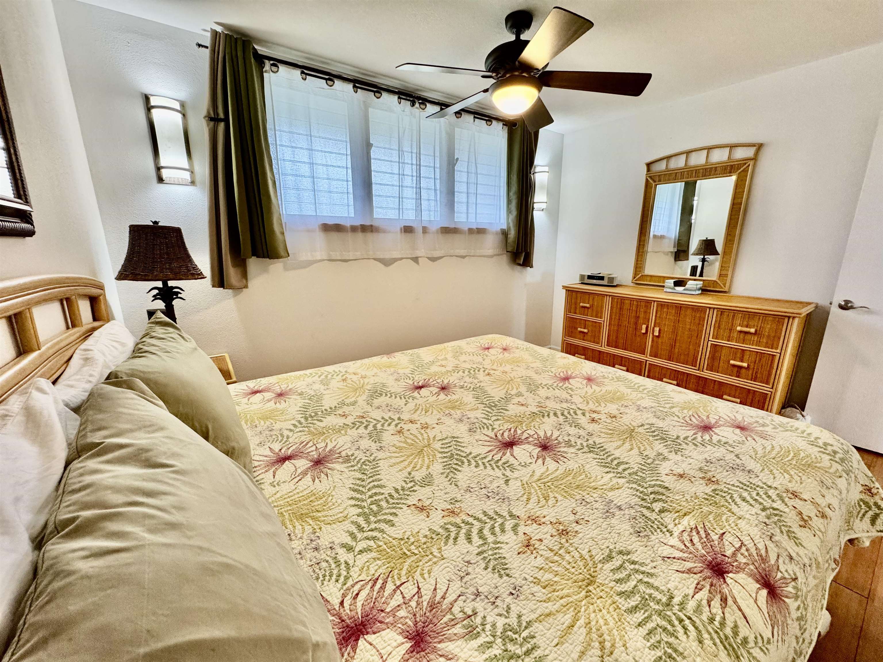7142 Kamehameha V Highway, Unit A110 Kaunakakai, HI 96748 - Photo 12 of 20 a bedroom with a large bed and a flat tv screen on dresser
