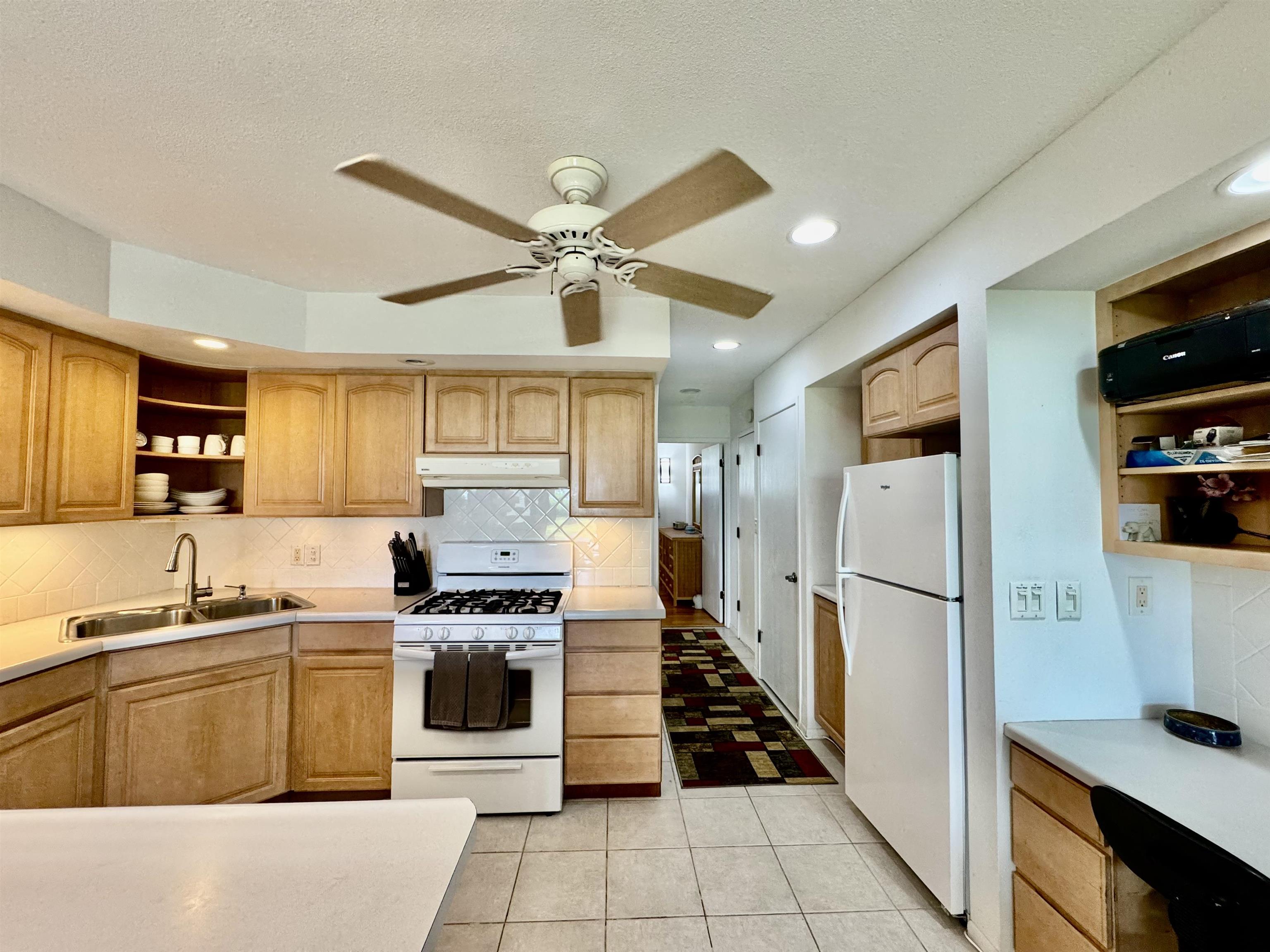 7142 Kamehameha V Highway, Unit A110 Kaunakakai, HI 96748 - Photo 16 of 20 a kitchen with stainless steel appliances a refrigerator sink and stove