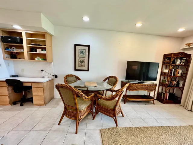 a workspace with stainless steel appliances refrigerator and cabinets