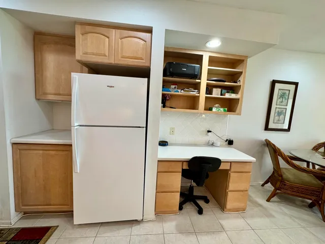 a view of a hallway with wooden floor and cabinets
