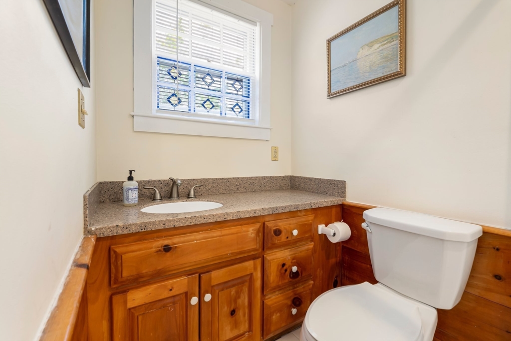 172 Union Street Weymouth, MA 02190 - Photo 18 of 40 a bathroom with a granite countertop toilet sink and mirror