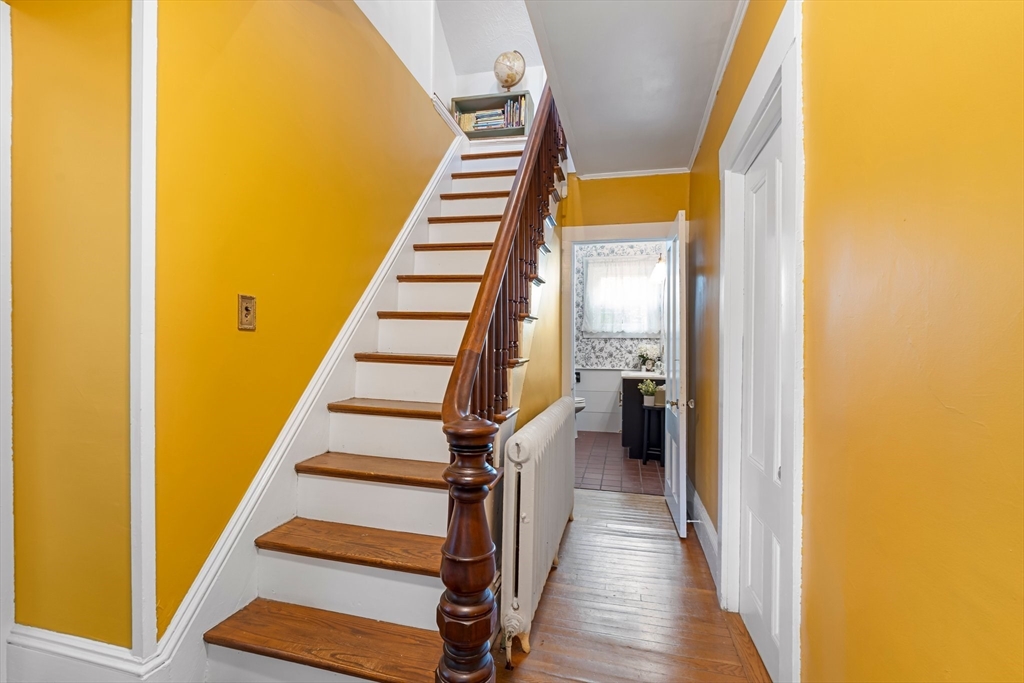 172 Union Street Weymouth, MA 02190 - Photo 19 of 40 a view of a hallway with wooden floor and staircase