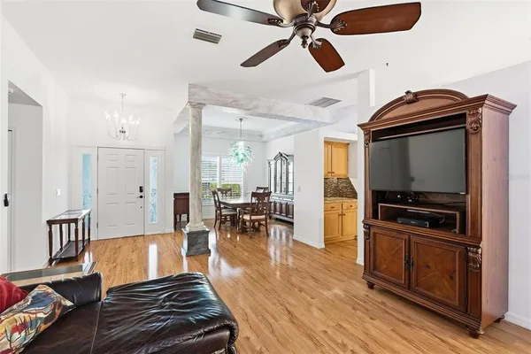 an empty room with a ceiling fan and a window