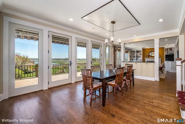 a view of a dining room with furniture window and wooden floor
