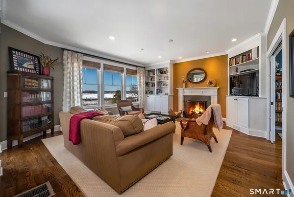 a living room with fireplace furniture and a flat screen tv