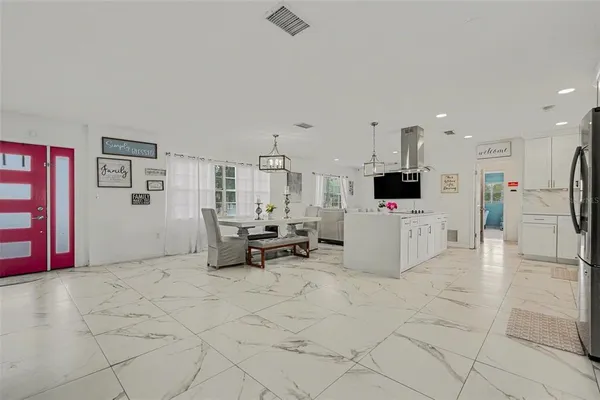 a view of kitchen with furniture and refrigerator