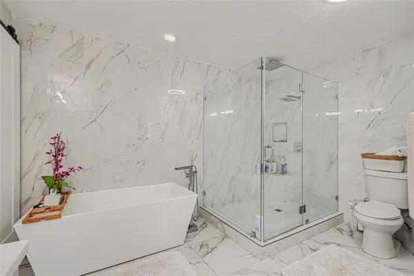 a white bath tub sitting next to a toilet
