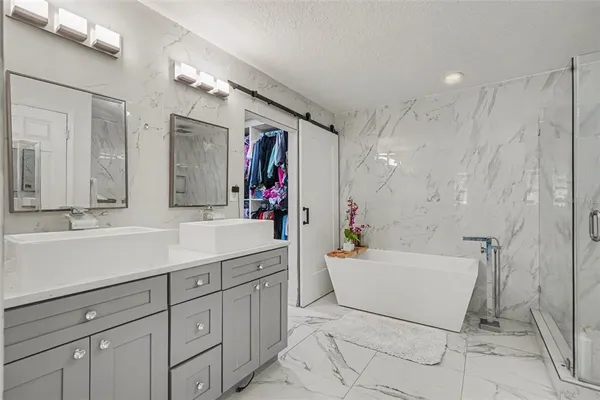 a bathroom with a sink mirror and a bathtub