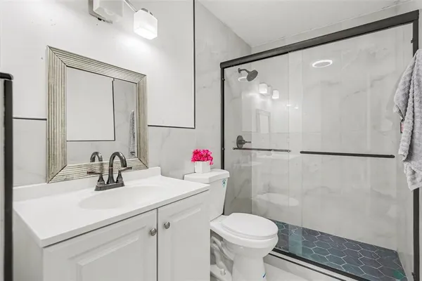 a bathroom with a sink toilet and shower