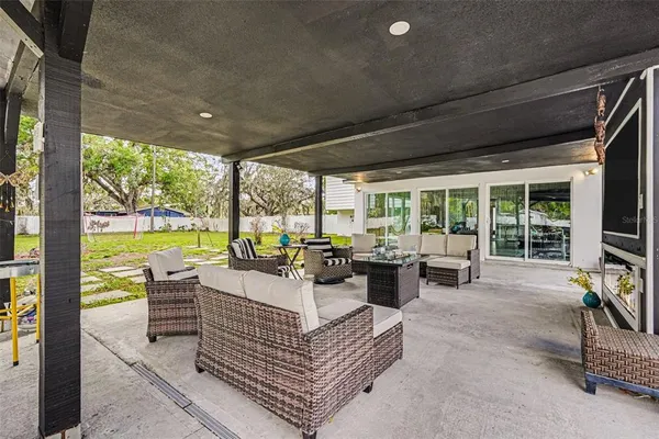 a view of a patio with chairs and floor to ceiling window
