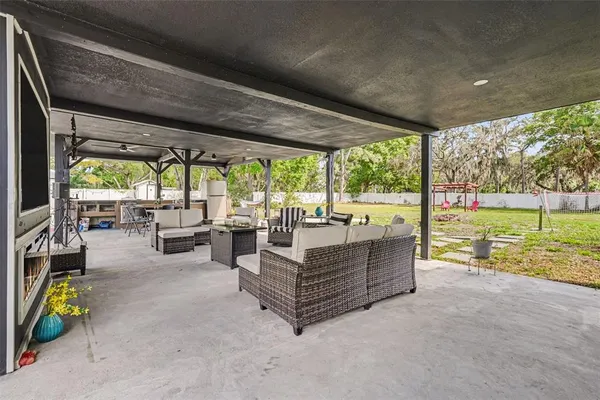 a living room with couch and a garden