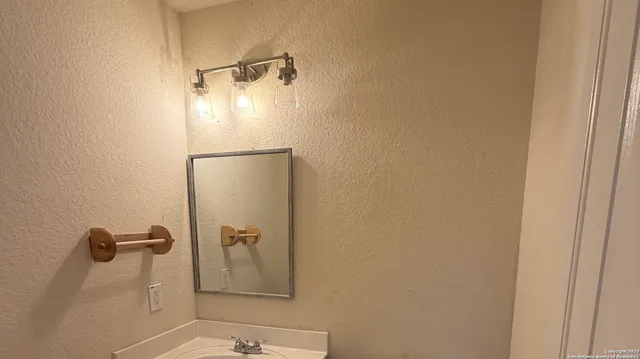 a view of empty room with wooden floor and window