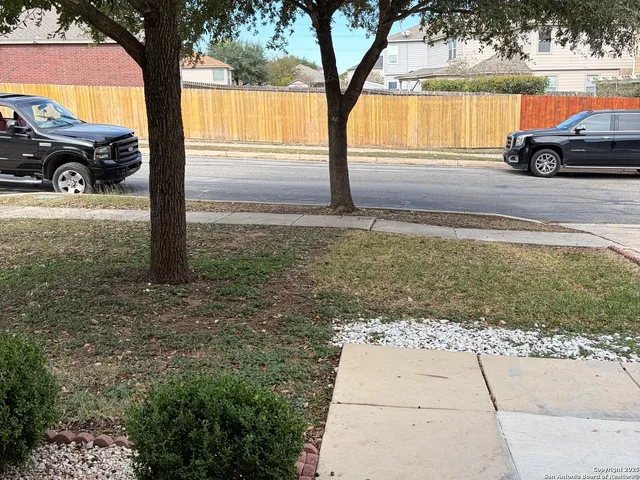 a view of a yard with car parked