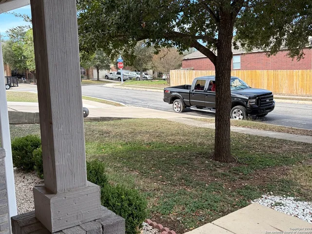 a street view with couple of cars parked on road