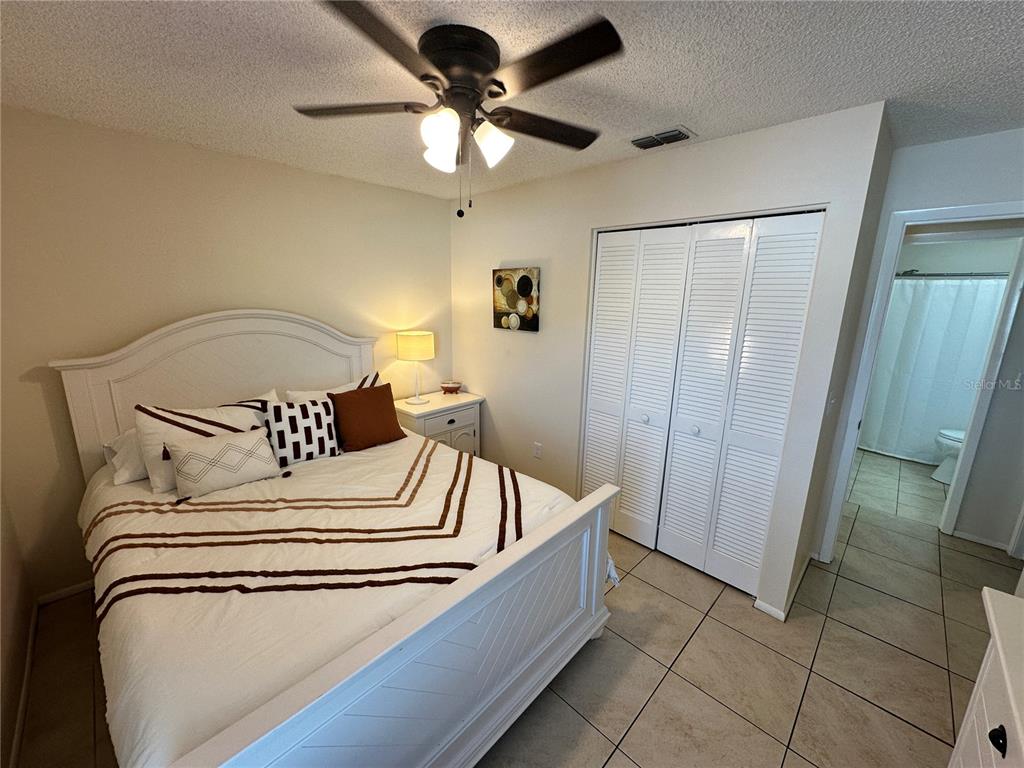 3846 59th Avenue West, Unit 3846 Bradenton, FL 34210 - Photo 16 of 25 a bedroom with a bed and a ceiling fan