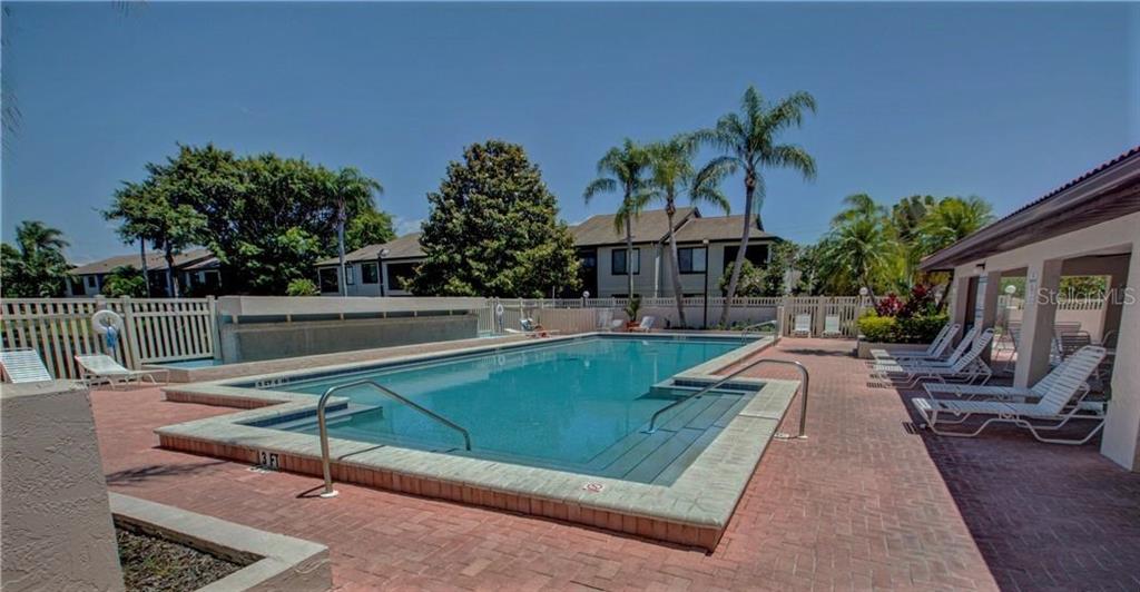 3846 59th Avenue West, Unit 3846 Bradenton, FL 34210 - Photo 19 of 25 a view of swimming pool with outdoor seating and plants