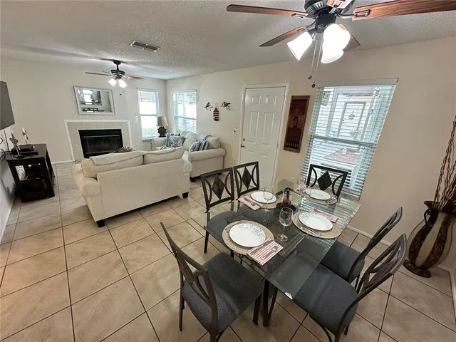 a view of a dining room with furniture and a chandelier