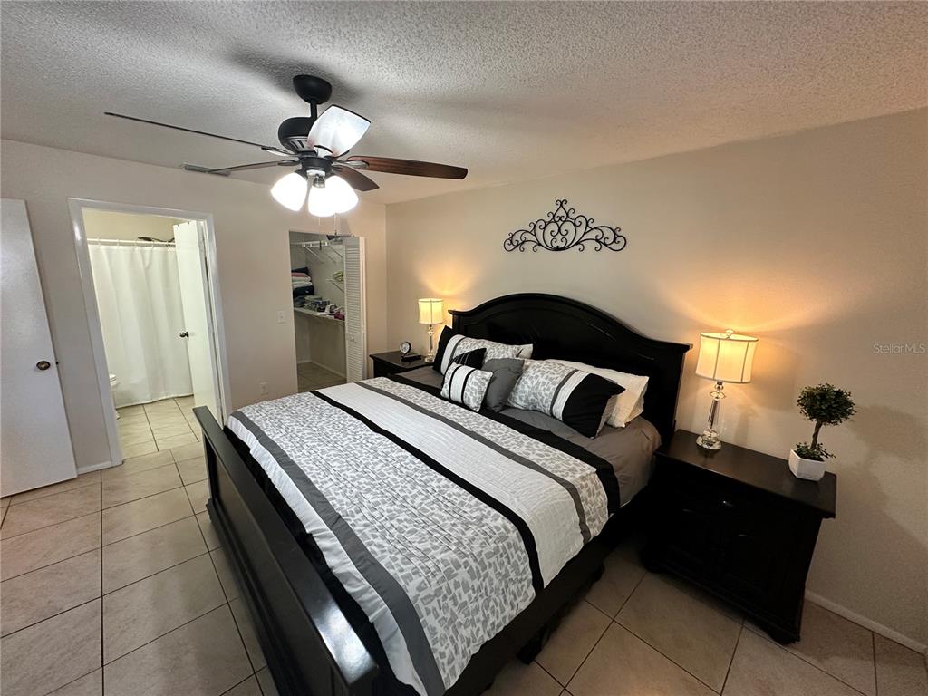 3846 59th Avenue West, Unit 3846 Bradenton, FL 34210 - Photo 10 of 25 a bedroom with a bed and a chandelier