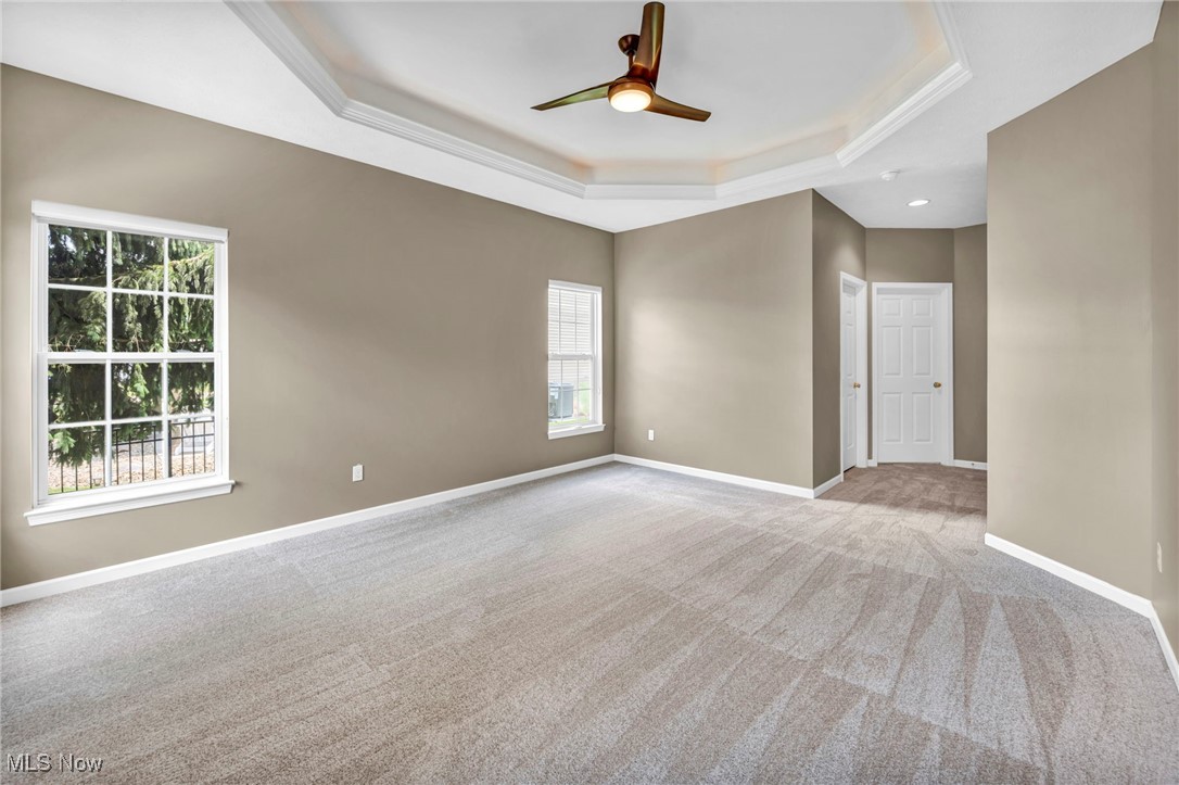 143 Stone Ridge Way Berea, OH 44017 - Photo 15 of 47 Carpeted spare room with a tray ceiling, a ceiling fan, crown molding, and recessed lighting