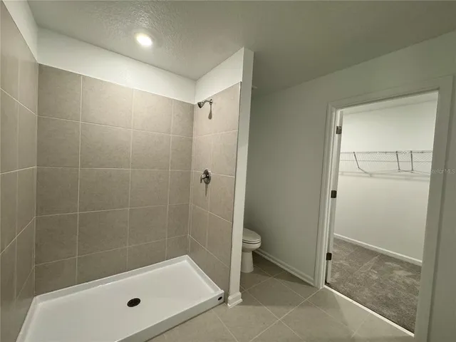 a bathroom with a shower and a toilet