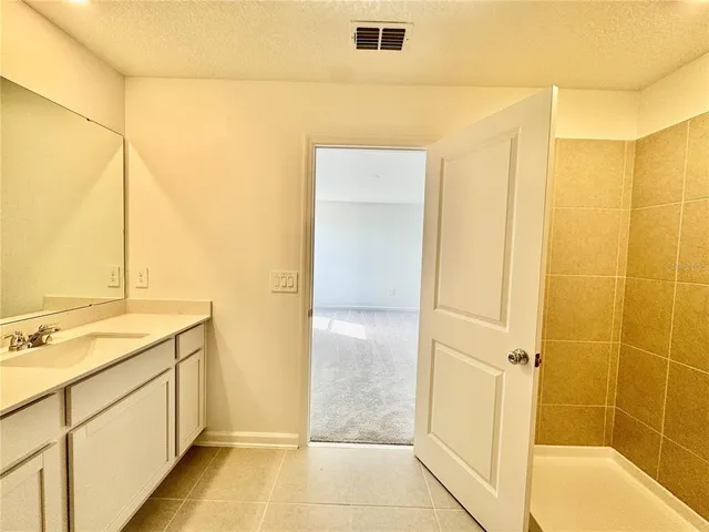 a bathroom with a shower and a sink
