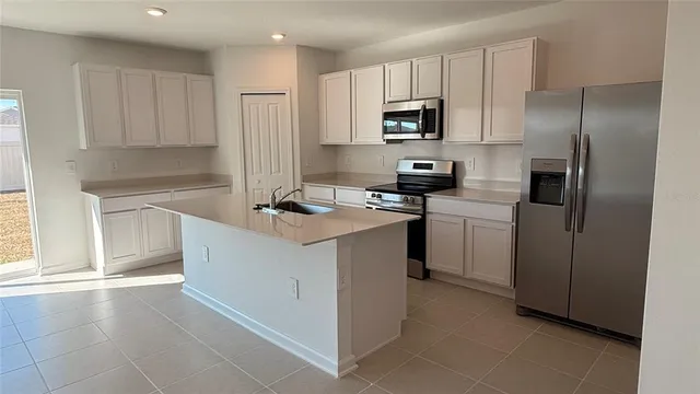 a kitchen with a sink appliances and cabinets