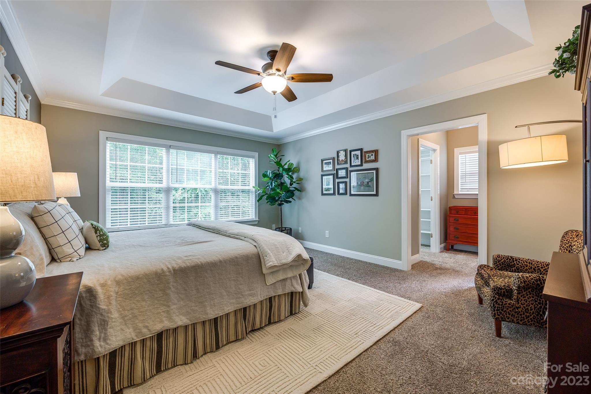 4142 Sunset Ridge Drive, Unit 117 Rock Hill, SC 29732 - Photo 16 of 48 a bedroom with a large bed and a chandelier