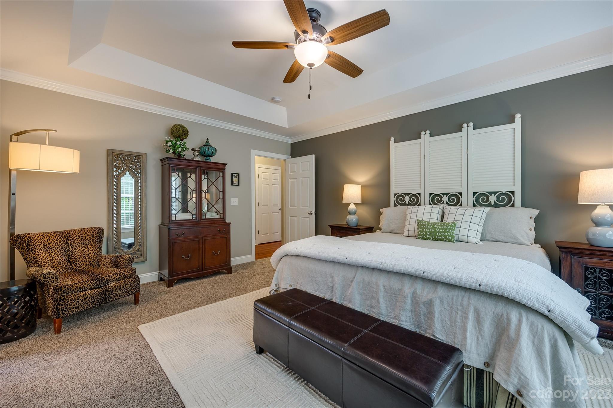 4142 Sunset Ridge Drive, Unit 117 Rock Hill, SC 29732 - Photo 18 of 48 a spacious bedroom with a bed a couch and a chandelier