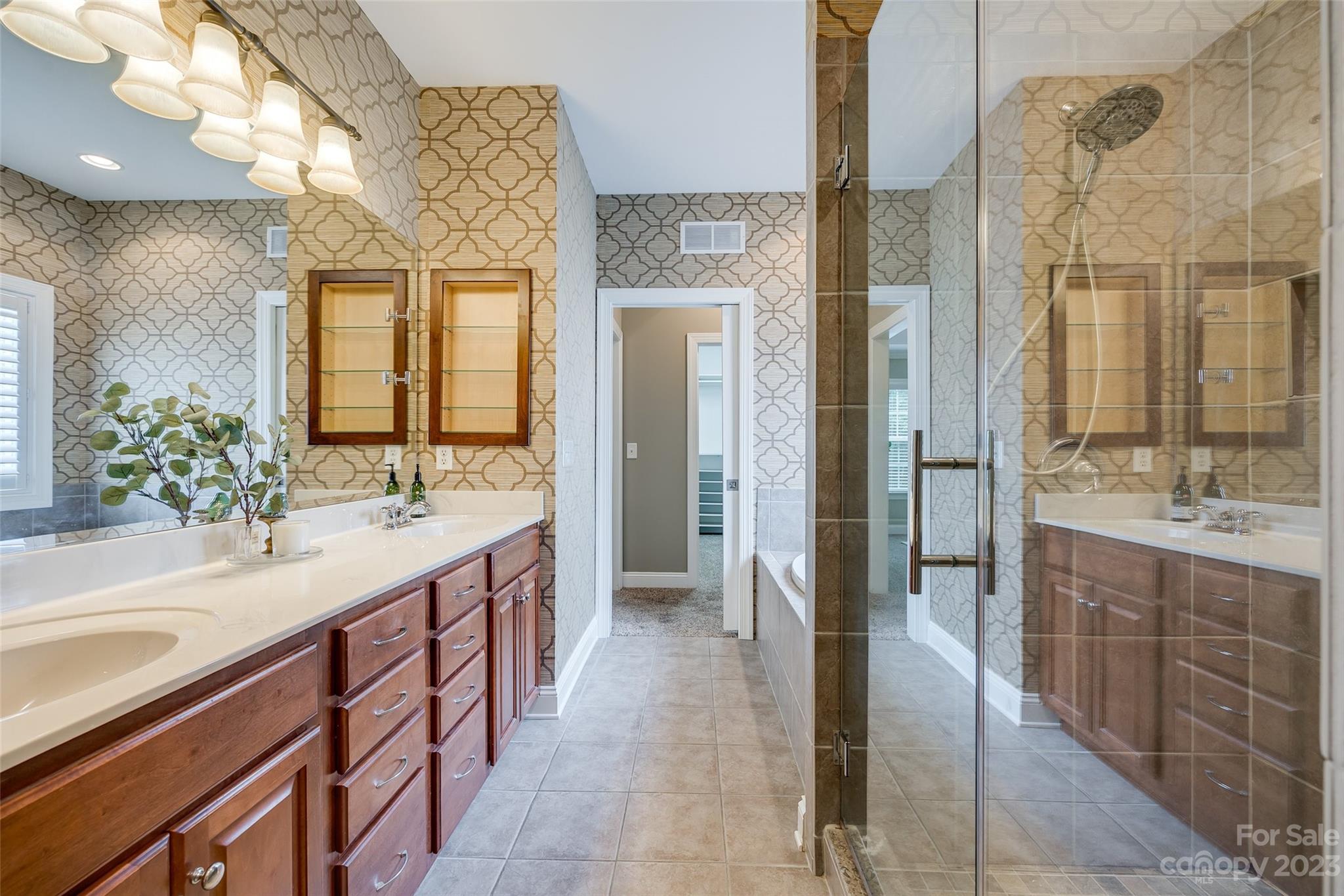 4142 Sunset Ridge Drive, Unit 117 Rock Hill, SC 29732 - Photo 22 of 48 a bathroom with a double vanity sink a toilet a mirror and shower
