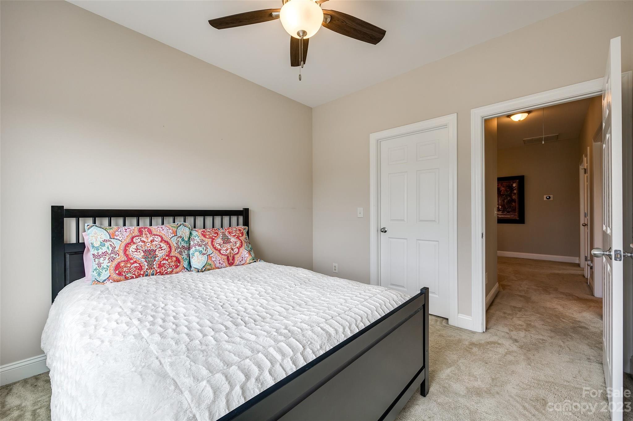 4142 Sunset Ridge Drive, Unit 117 Rock Hill, SC 29732 - Photo 24 of 48 a bedroom with a large bed and a chandelier